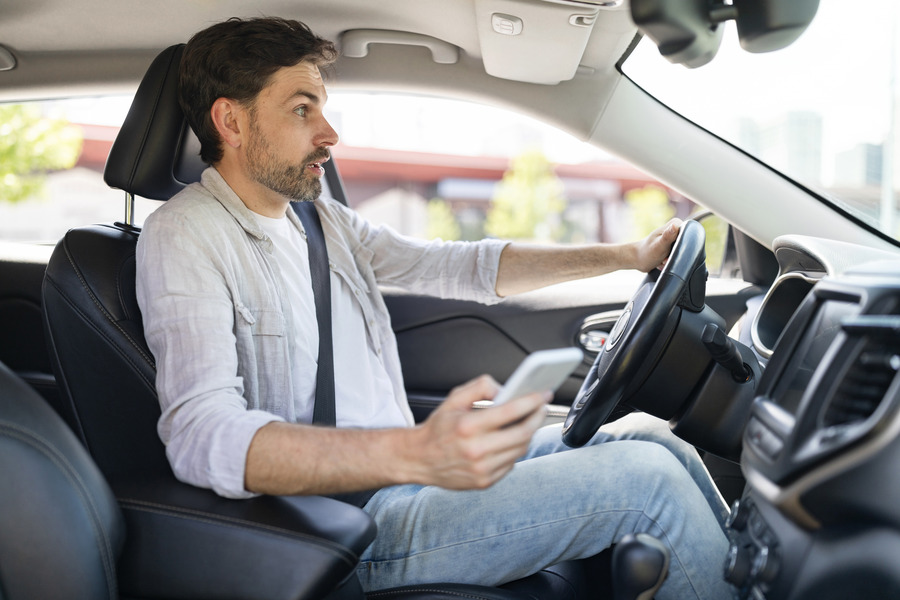 Man Distracted By Phone While Driving